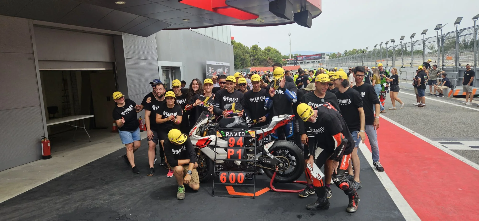 Kyle Payne and the team in the pit lane after a race win